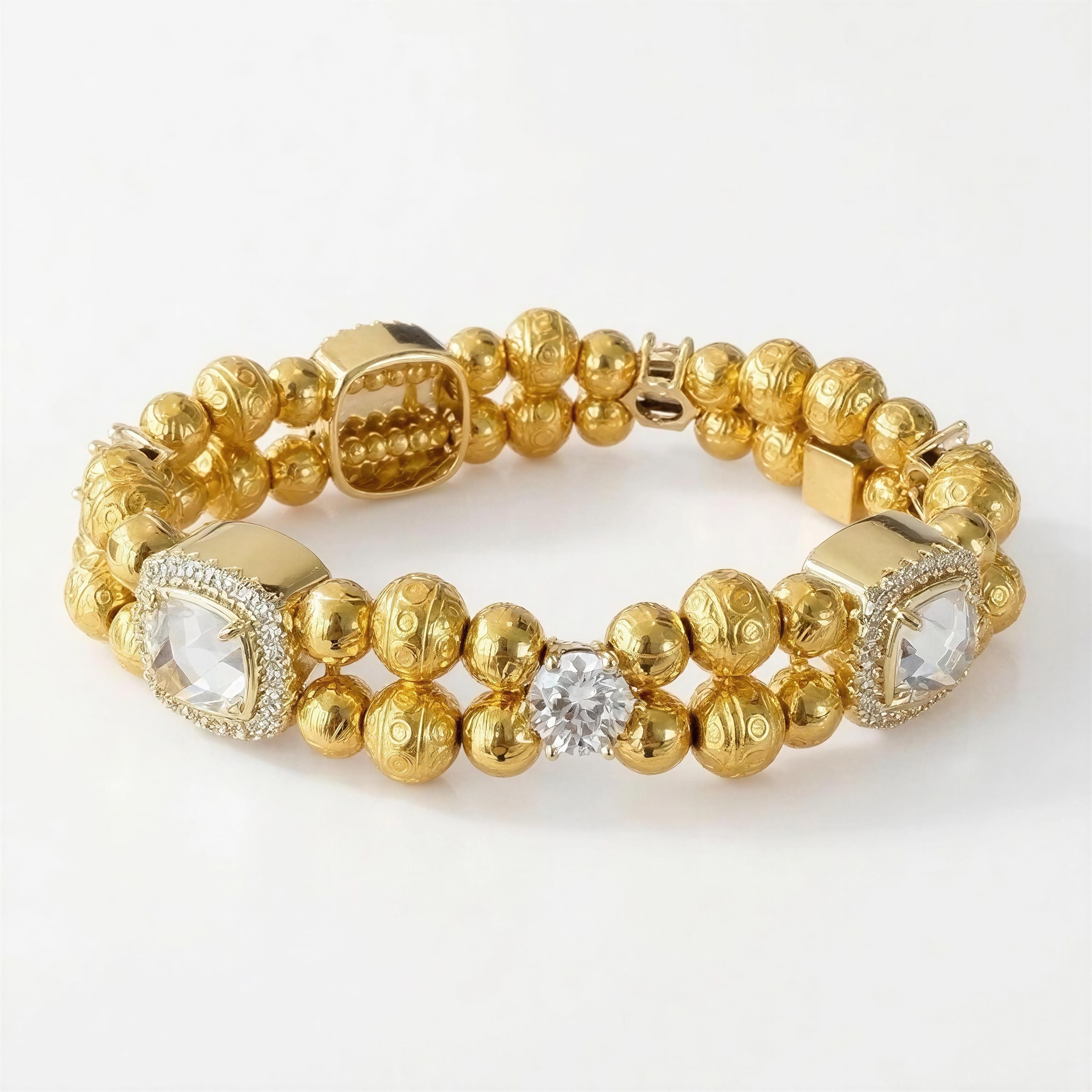 Elegant gold beaded bracelet featuring intricate textured spheres, clear gemstone accents, and a central sparkling crystal, designed as the XX ÉLÉGANCE LIMITED EDITION luxury piece.