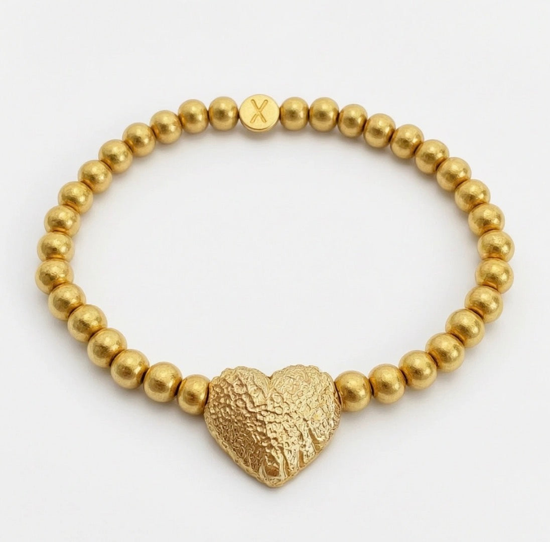 Timeless Collection - Amor Aurea gold beaded bracelet featuring a textured heart centerpiece, showcasing handcrafted luxury and elegant designer jewelry craftsmanship.