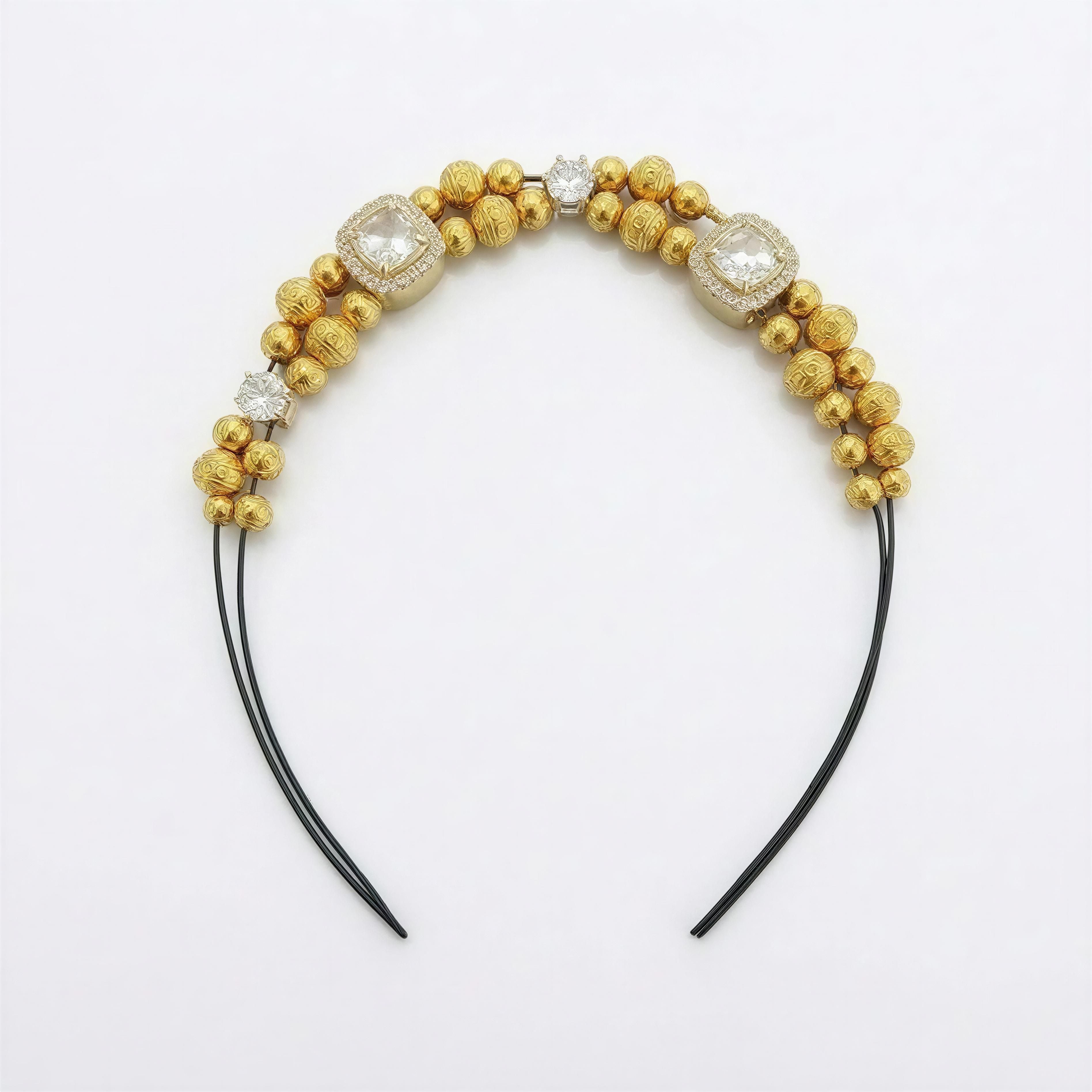 Luxury designer headband XX ÉLÉGANCE LIMITED EDITION featuring handcrafted gold beads, shimmering goldleaf accents, and clear crystal embellishments on a black band.