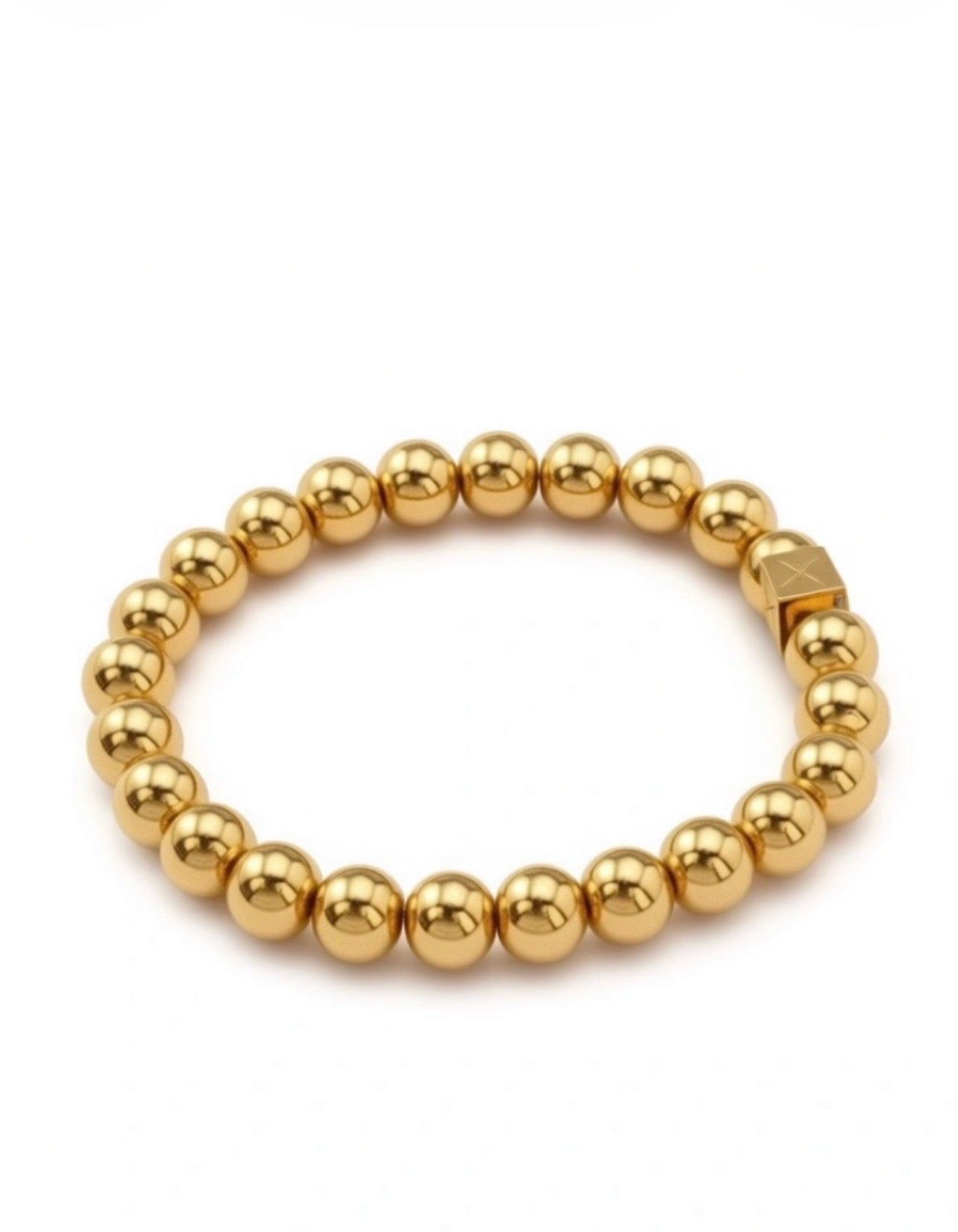 Close-up of a gold bead bracelet from The Essential Collection - 8mm, featuring polished round beads and a square accent bead with an engraved design.
