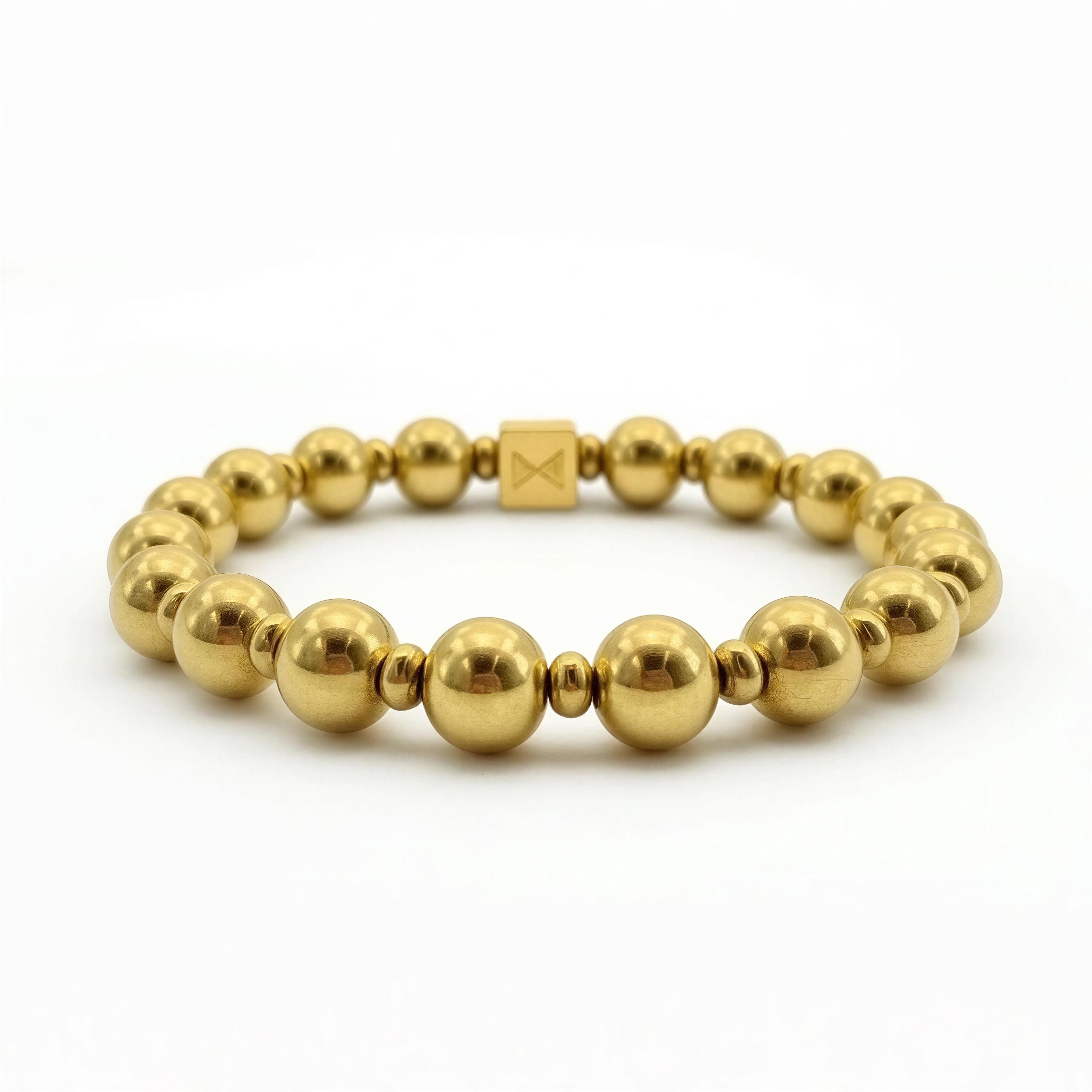 A luxurious gold beaded bracelet featuring polished spheres and a square clasp, part of The Essential Collection - 8mm & 4mm, showcasing handcrafted Atelier X elegance.