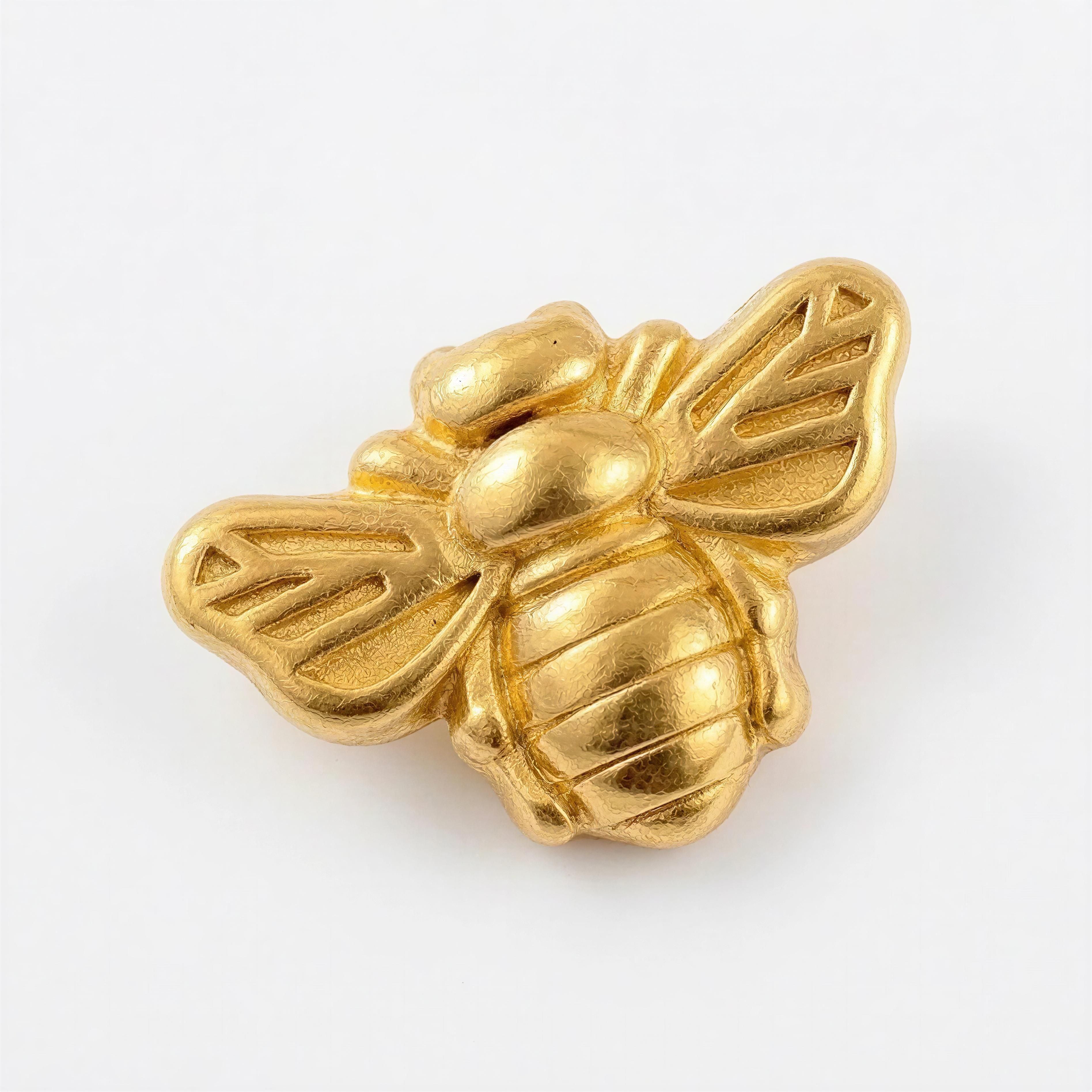 Close-up of a gold-toned bee-shaped bead with intricate wing and body details, part of the Timeless Collection - Regina Apis handcrafted luxury jewelry.