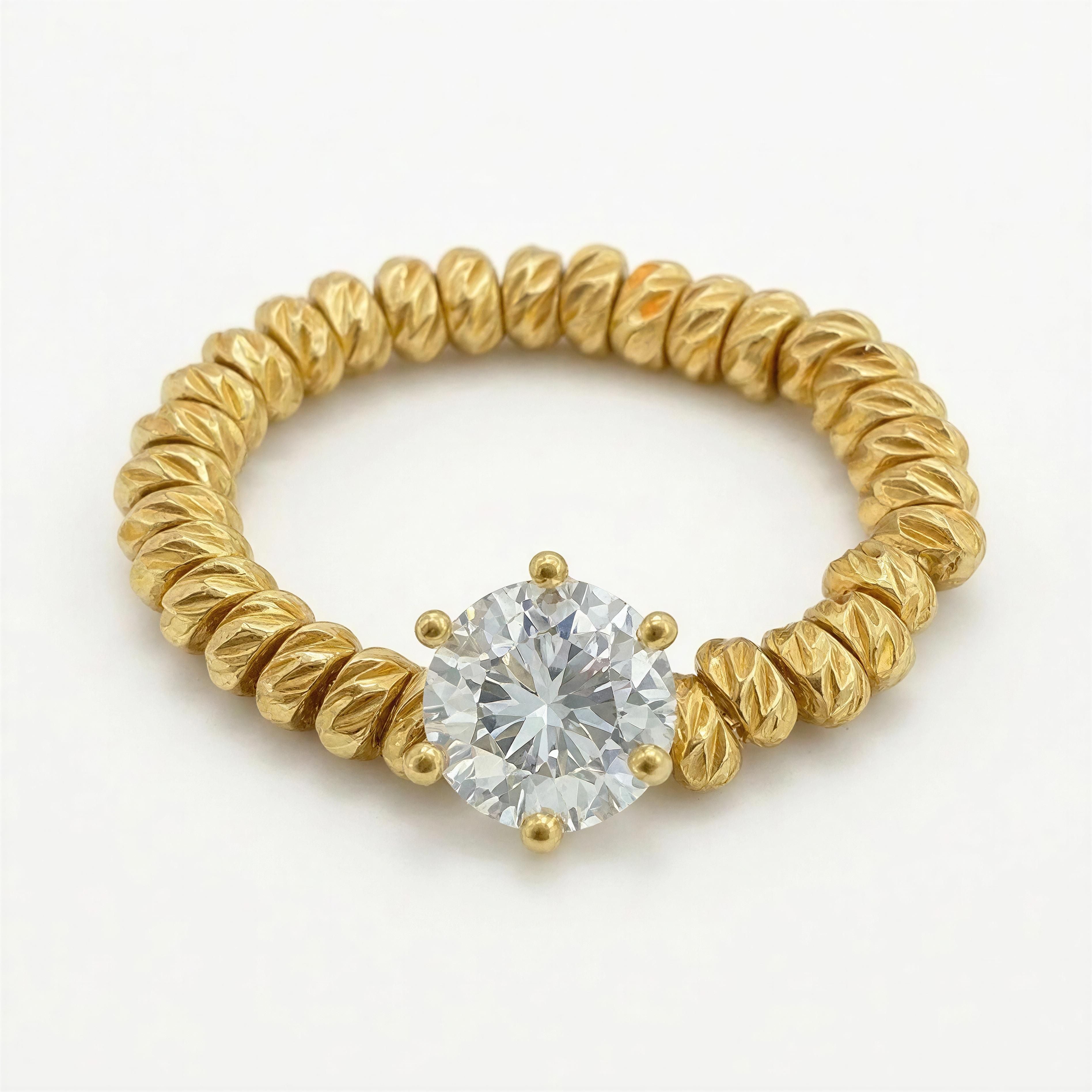 A finely crafted RING - Golden Radiance featuring textured gold beads forming the band and a prominent sparkling clear gemstone centerpiece, radiating elegance and luxury.