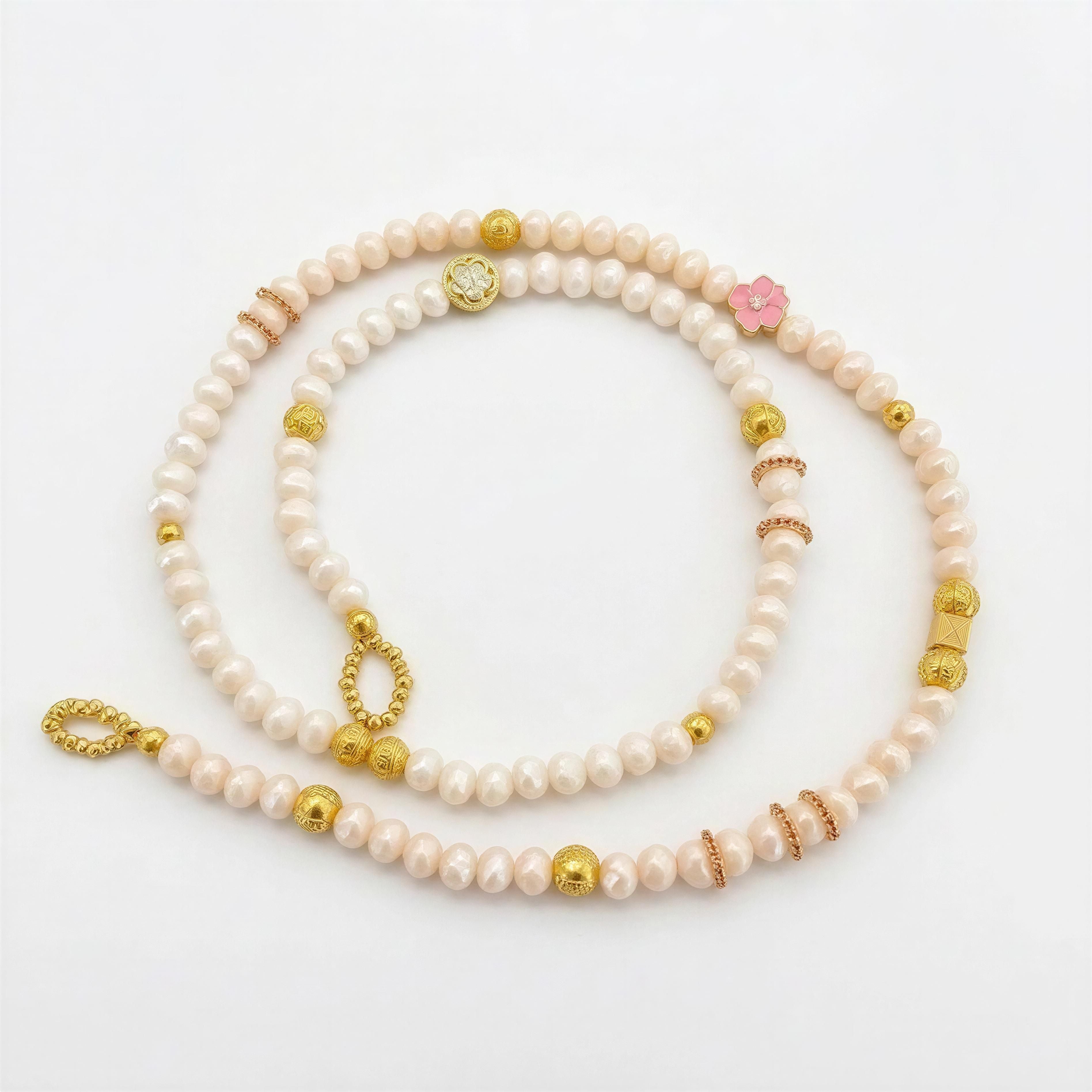 The Riviera Sunglass Chain – Rosé Lumière featuring delicate light pink beads, gold and rose gold accents, and a small pink flower charm, ideal for stylish eyewear accessorizing.