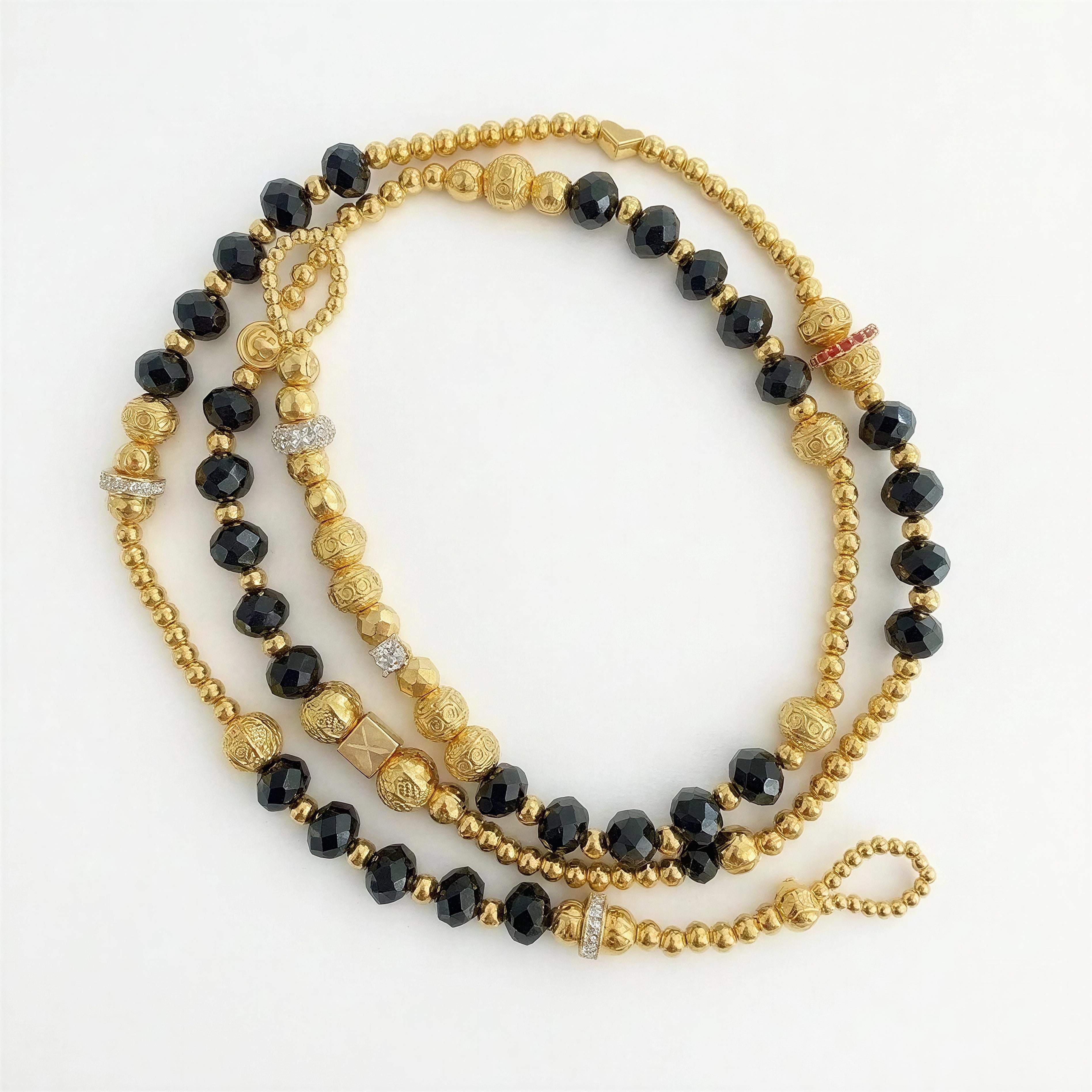 The Riviera Sunglass Chain - Noir Élégance featuring a luxurious blend of faceted black beads and intricately detailed gold beads with sparkling accents for a sophisticated touch.