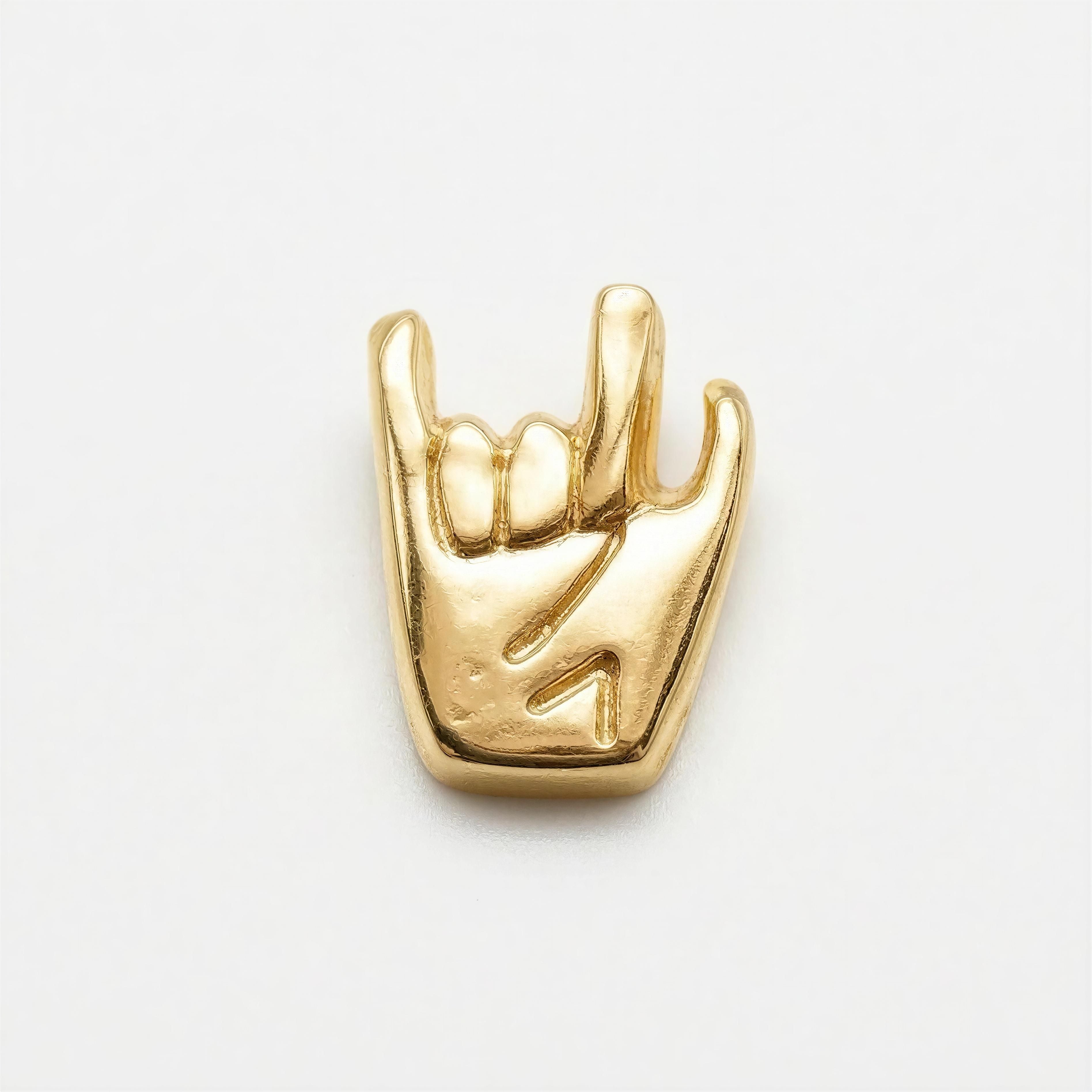 A polished gold charm shaped like a hand making the "rock on" gesture, showcasing intricate detail and craftsmanship for The Little Icons - Manus Ferox.